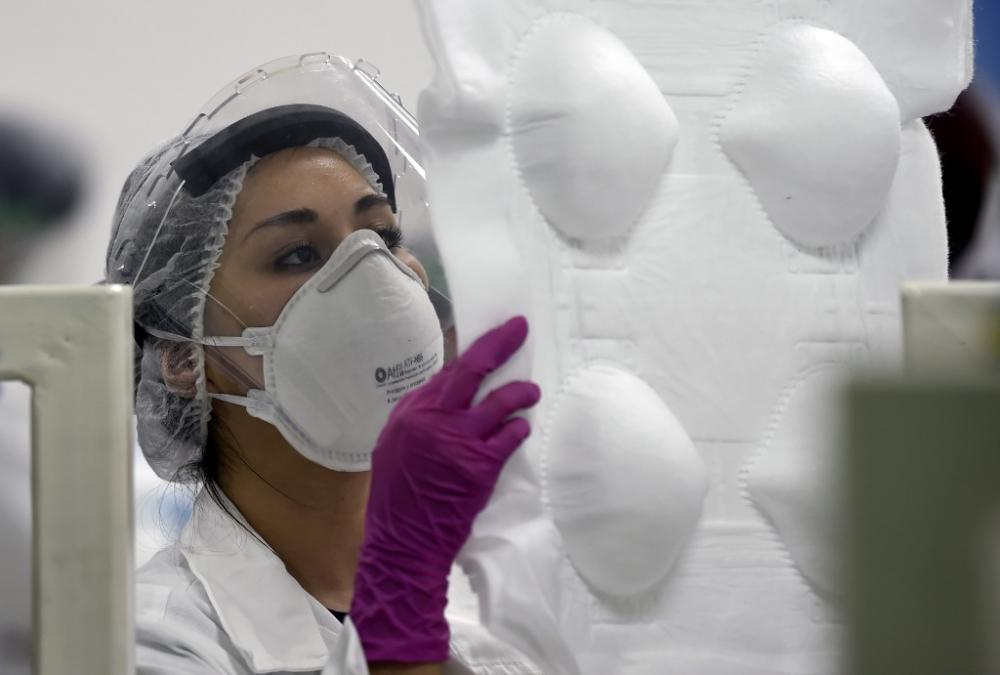 An employee works in the production of N95 face masks at a factory that produces 40,000 N95 masks per day, in Mexico City on May 21, 2020. Photo by Alfredo Estrella / AFP