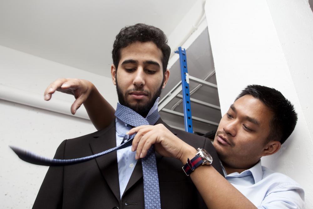  Patrick Zachmann pictured this scene above at "La Cravate Solidaire," an association that trains jobseekers before recruiting interviews. Here an advisor teaches how to tie a tie