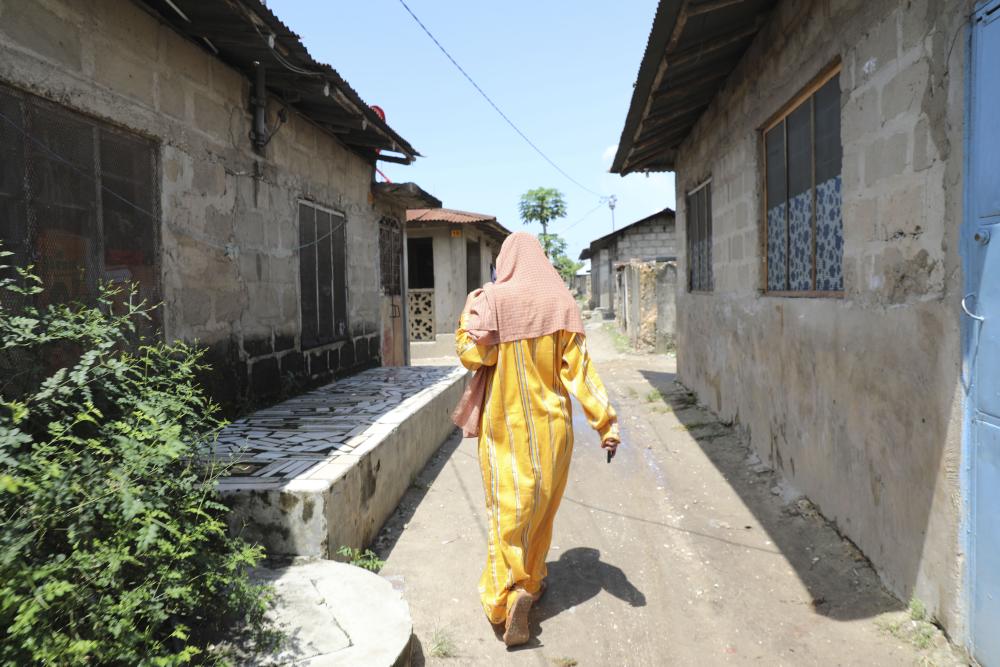 This woman, walking with determination down a street in Stone Town, Zanzibar, Tanzania, was photographed by Sabiha Çimen in 2022