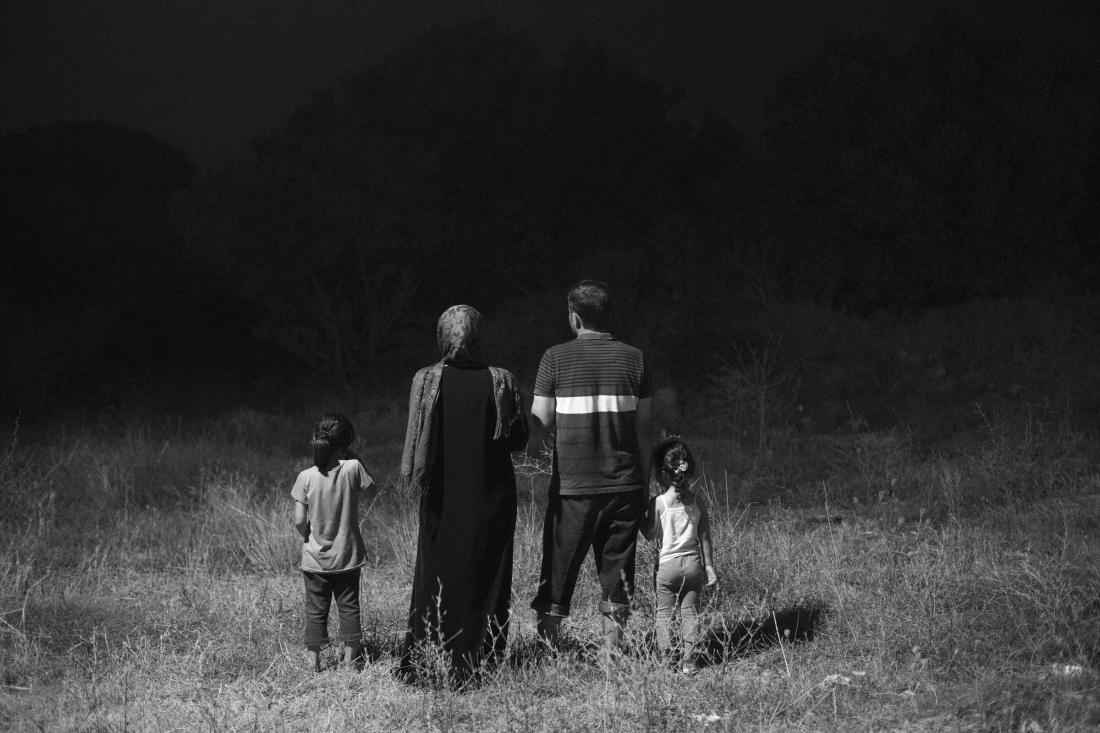 A family of Syrian refugees stand together in Kos, Greece. Photo Paolo Pellegrin / Magnum Photos