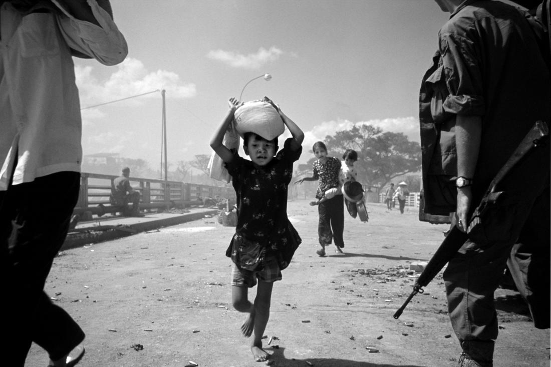 Saigon, Vietnam. Refugees under fire. 1968. Philip Jones Griffiths / Magnum Photos