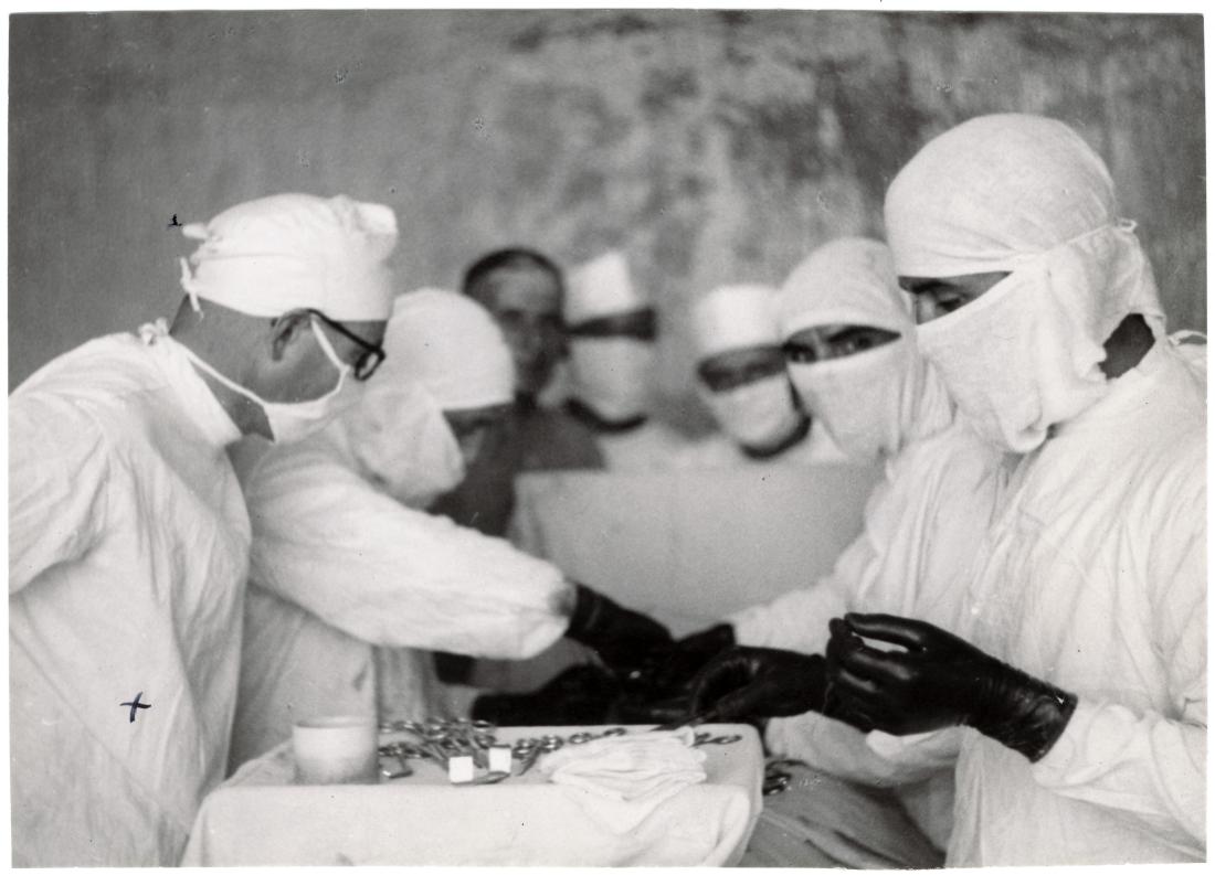 Photo caption: 1939-1945. British Indies. Group II. Italian prisoner of war camp. ICRC doctor-delegate attending an appendix removing.